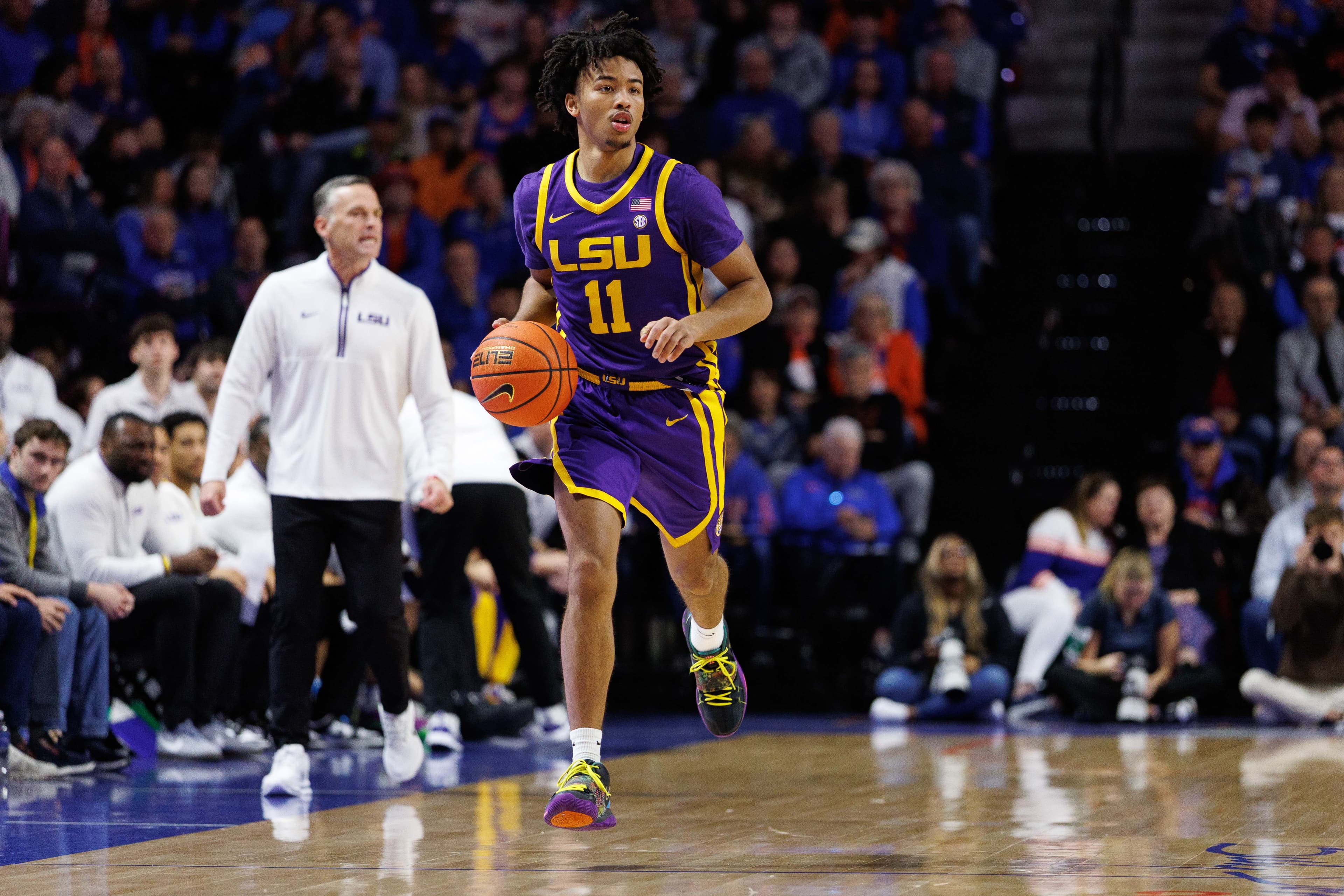 Jan 20, 2026; Gainesville, Florida, USA; Louisiana State Tigers guard Dedan Thomas Jr. (11) dribbles the ball against the Florida Gators during the first half at Exactech Arena at the Stephen C. O'Connell Center.